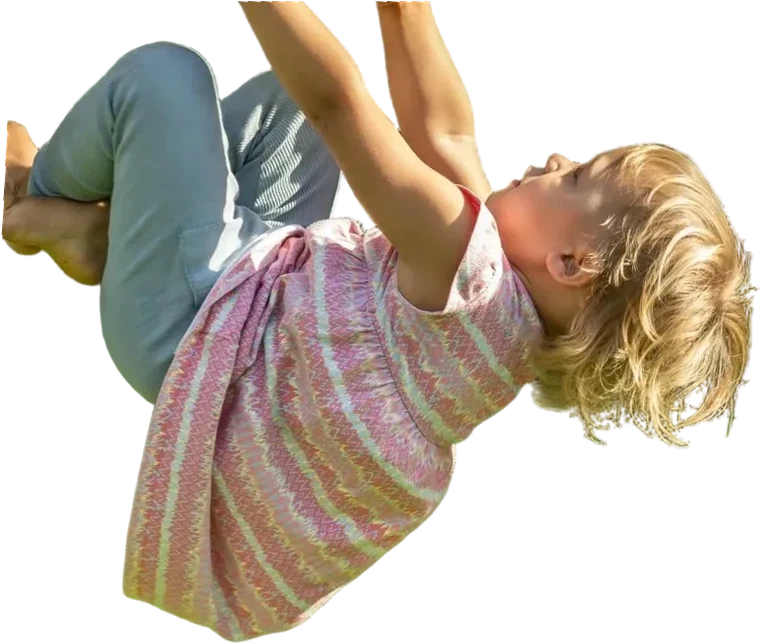 Kleines Mädchen hängt mit beiden Händen an der Stange und stemmt die Füße gegen den Pfosten